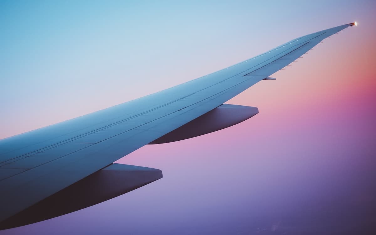 Aircraft wing in flight at dusk
